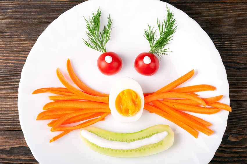 Funny breakfast or lunch for kids with vegetables, egg and herbs. Healthy food. Top view