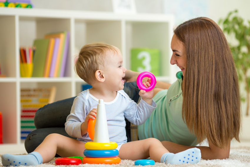 cute mother and baby child play together indoors at home